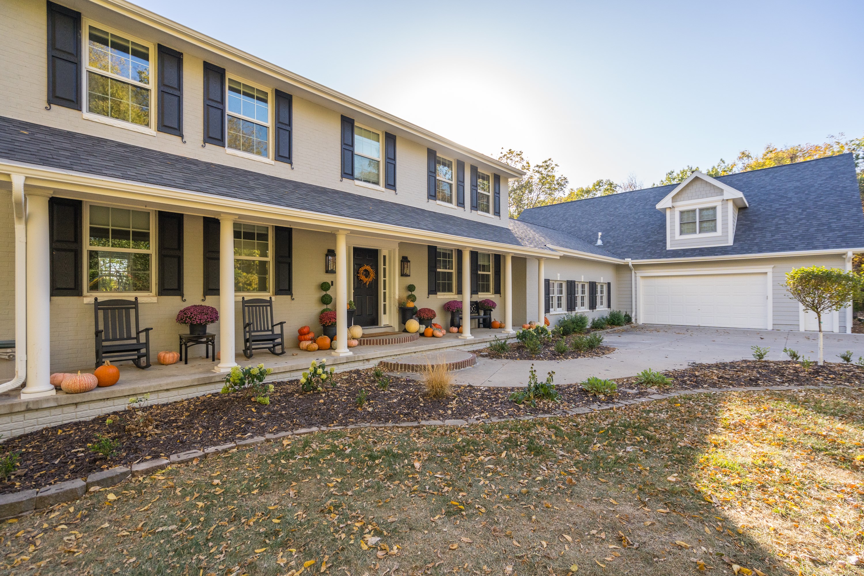 Colonial style home with front porch and fall decor