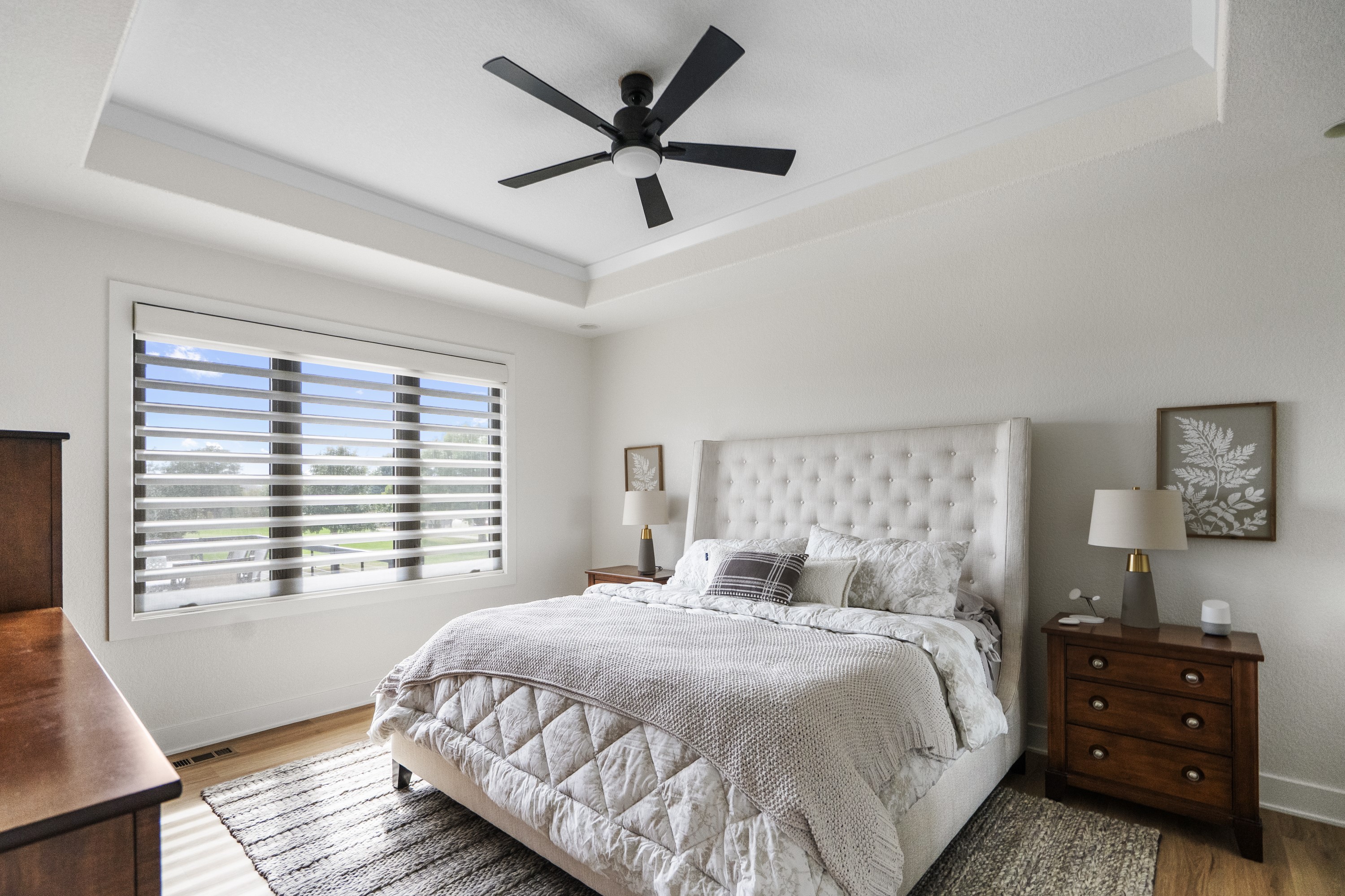 Master bedroom with tray ceiling and plantation shutters