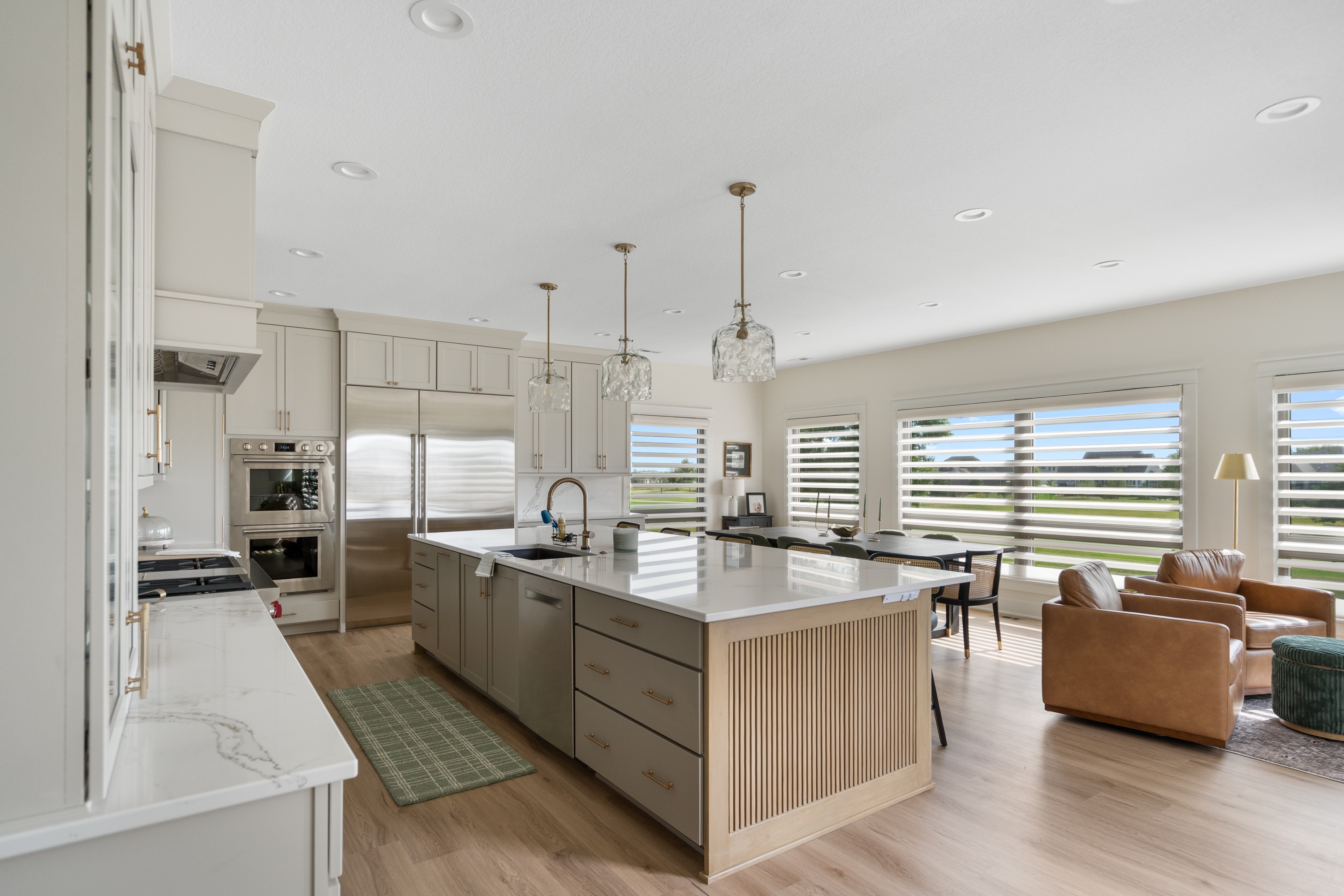 Modern kitchen remodel with quartz countertops, custom island, and open concept living area