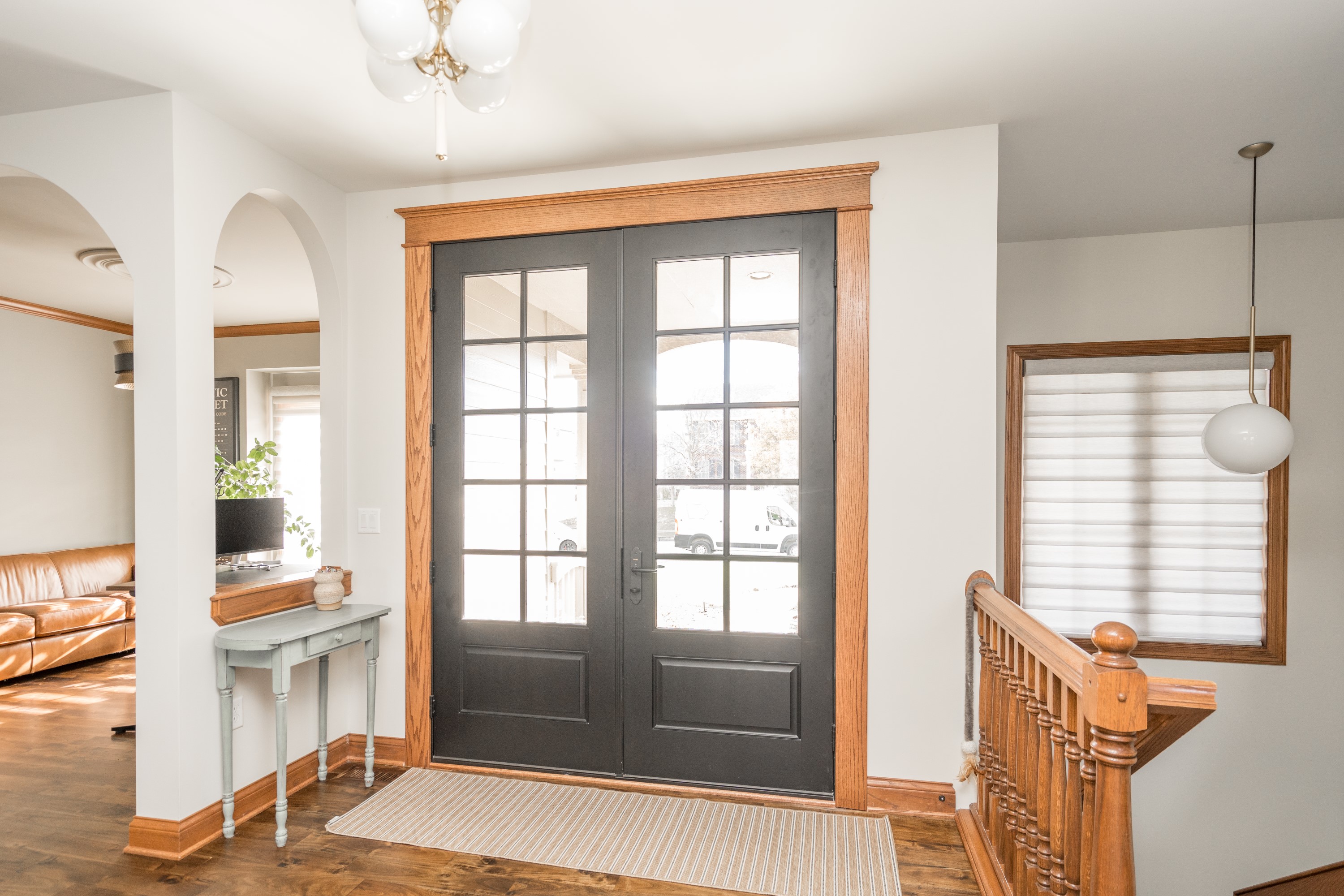 Entry foyer with French doors and wood staircase