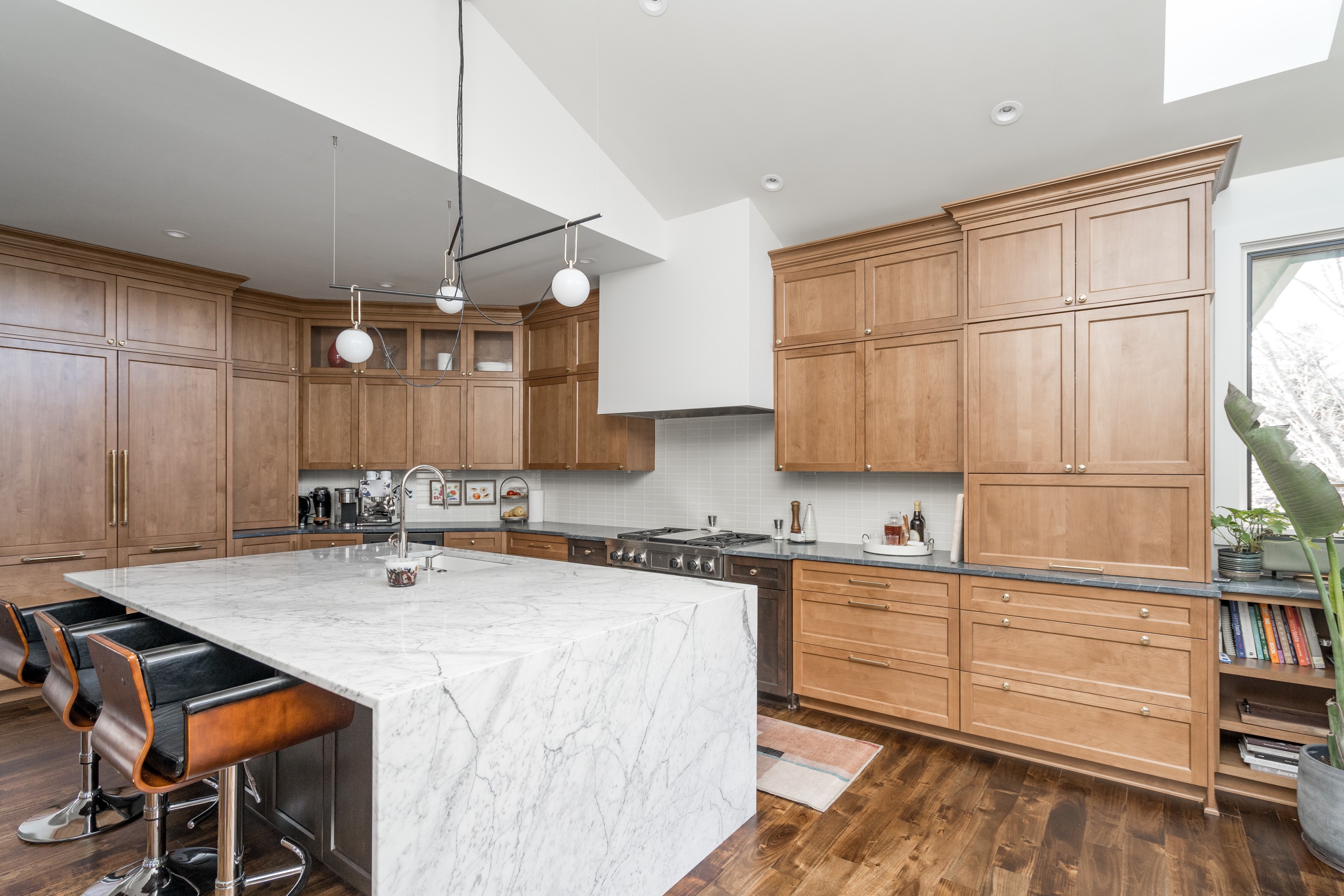 Kitchen island with marble countertop and bar seating