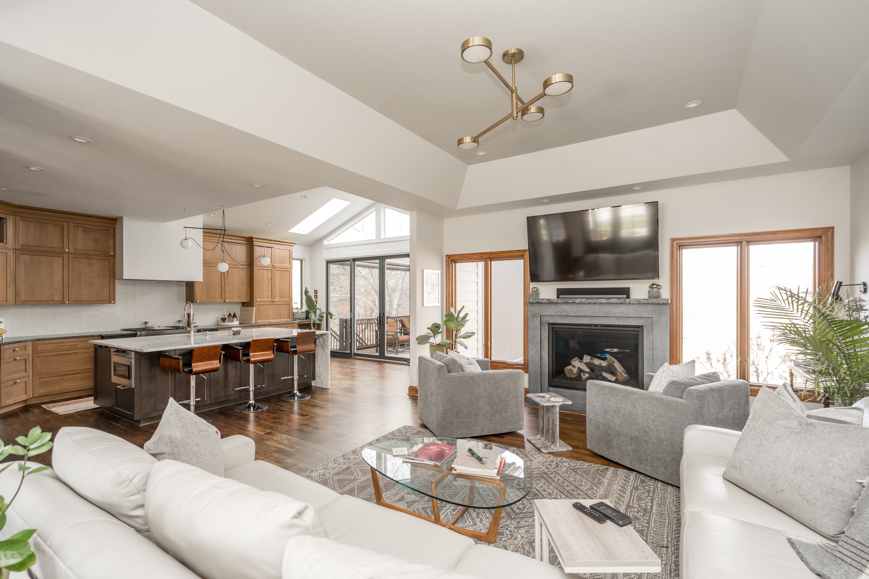 Open concept living room with fireplace and kitchen view